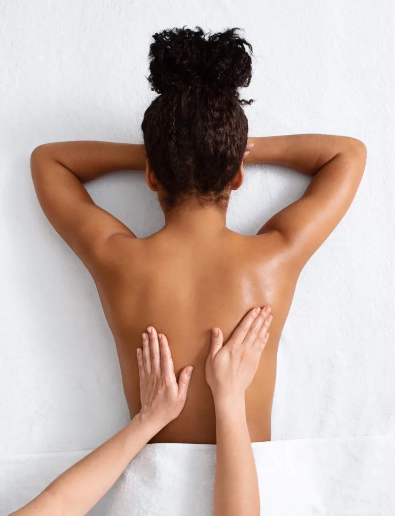 Frau liegt auf der Liege und erhält eine Ganzkörpermassage in zum Thema Ganzkörpermassage Karlsruhe - Frau bekommt eine in Ganzkörpermassage
